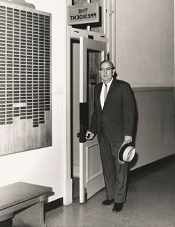 "Roll of Honor" Valk - Northwest's sixth president, J.W. Jones, stands outside his office in the Administration Building. The World War II Roll of Honor is displayed on the right. The Roll of Honor is now displayed in Valk Center.